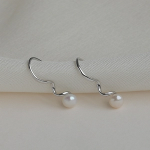 Elegant S925 silver wave design drop earrings with white round pearls on soft fabric