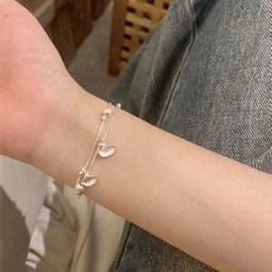 Double-layer S925 silver ginkgo leaf bracelet with round beads worn on a wrist
