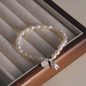 Detail von S925 Silber Tulpen- und Blumenanhängern an einem Süßwasserperlenarmband in der Box