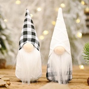 Detail of two Christmas gnomes with black and white plaid hats and long white beards