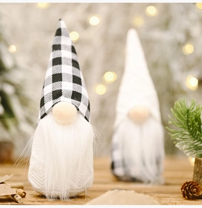 Detail of knit texture and black and white plaid hat on a plush Christmas gnome