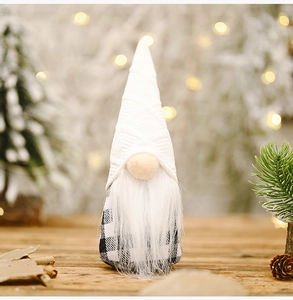 Detail of a Nordic Christmas gnome with black and white buffalo plaid on a wooden surface