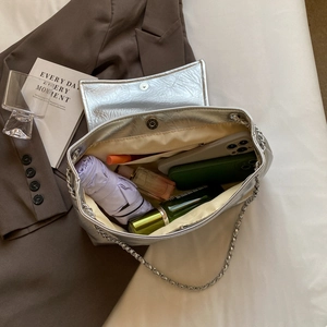 Silver metallic tote bag with chain strap showing large capacity for essentials