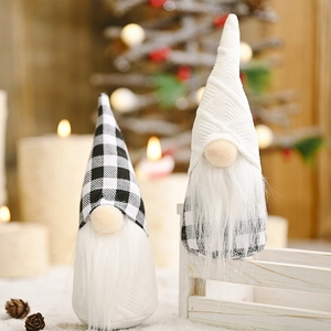 Pair of festive black and white plaid Christmas gnomes on snowy background with lights