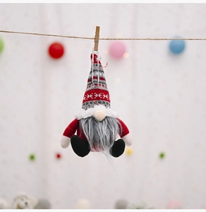 Christmas knitted gnome ornament with snowflake patterns hanging on a twine rope