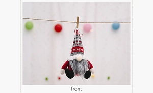 Detail of Christmas gnome plush with red knitted snowflake hat and long grey beard