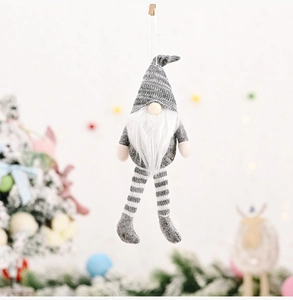 Detailed view of handmade knitted Christmas gnome with grey striped hat and white beard