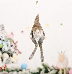 Close-up of a handmade Christmas gnome with a brown striped hat and white beard detail
