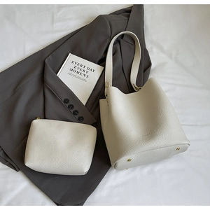 White lychee leather bucket bag with matching inner pouch and protective bottom studs