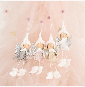 Detailed view of four plush angel dolls with glittery wings and soft feather skirts