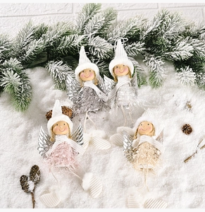 Detail of four plush Christmas angel doll ornaments with silver wings and knit hats