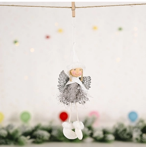 Detail of Christmas angel pendant with white knit hat and silver plush dress hanging by clip