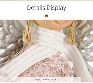 Macro detail of Christmas angel doll showing silver wings and premium fabric textures