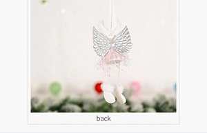 Back view of a plush Christmas angel ornament with silver wings and pink velvet dress
