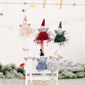 Detail of six Christmas angel plush dolls in different colors hanging on rustic twine