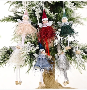 Detail of six colorful plush angel dolls with glitter wings hanging on a Christmas tree