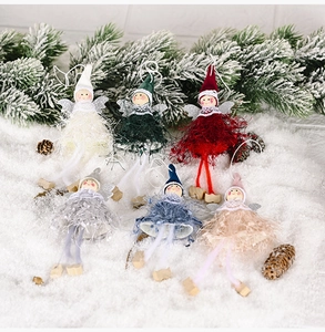 Detailed view of six colorful plush Christmas angel dolls on snow with wings and soft hats
