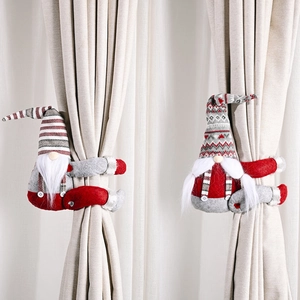 Detail of Christmas gnome curtain tiebacks in festive red and grey with stripe hats