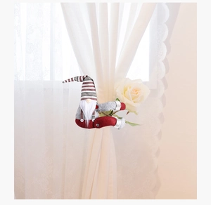 Christmas gnome curtain tieback with striped hat and white beard on lace curtains