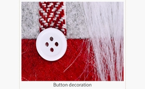 Detail of Christmas curtain buckle showing a white button and red striped knit fabric