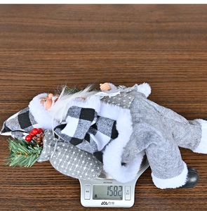Standing Santa Claus doll in grey plaid suit on digital scale weighing 158.2g