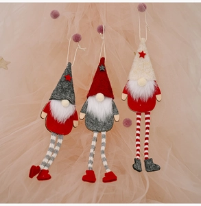 Three plush Christmas forest gnomes with long legs and star hats on a pink background