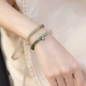 Elegant Chinese Hetian jade beaded bracelet set with silver lotus pendant and lucky charm