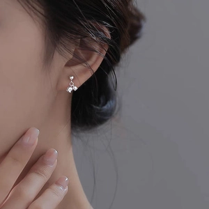 Elegant S925 silver lily of the valley earrings with shiny rhinestones on a female model