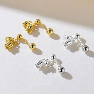 Macro view of Lily of the Valley earrings in gold and silver with screw ball backs
