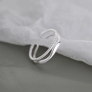 Adjustable silver layered ring featuring a twisted rope design and polished smooth band