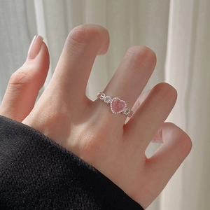 Pink heart-shaped cat-eye stone ring with silver band and sparkling zircon accents