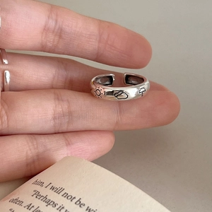 Minimalist adjustable silver ring featuring weather doodle sun and cloud engravings