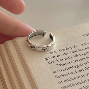 Adjustable silver ring featuring cloud and umbrella engravings on vintage book pages