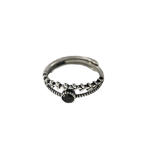 Vintage layered silver wheat ring with black zircon stone on white background