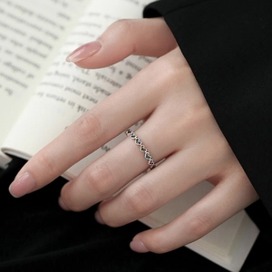 Minimalist silver ring featuring a continuous line of colorful zircon-set heart patterns