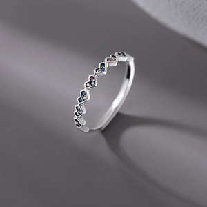 Detailed view of silver heart ring featuring multi-colored cubic zirconia inlay