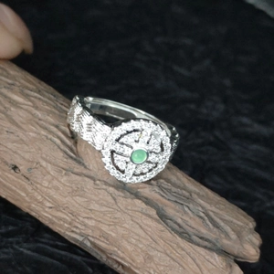 Lace woven Hetian jade ring with diamonds and adjustable silver band on wood