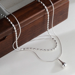 Double-layered silver necklace set featuring water drop pendant and oval bead chain details