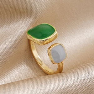 Adjustable gold open ring featuring asymmetrical green and white geometric resin blocks