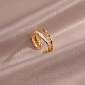 Modern layered wave ring in gold with white enamel inlay and adjustable opening