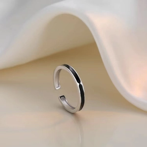 Minimalist irregular geometric silver ring with black enamel line in an open design