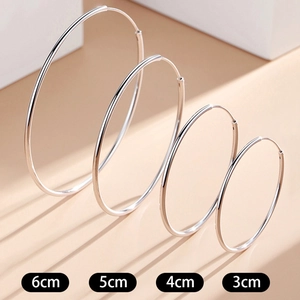 Set of four minimalist silver oversized hoop earrings in 3cm, 4cm, 5cm, and 6cm sizes