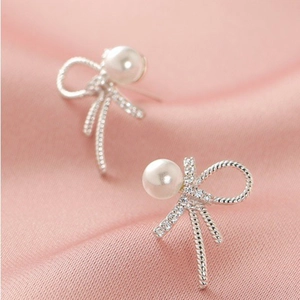 Elegant S925 silver bow stud earrings with white pearl and sparkling zircon accents