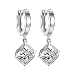 Minimalist silver hoop earrings with hollow cube zircon pendants on white background