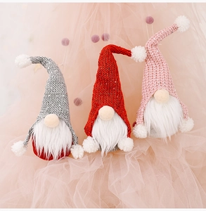Three Christmas gnomes with knitted hats in red, grey, and pink for festive home decor
