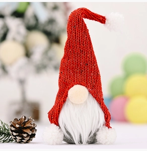 Close-up of a Christmas gnome doll with red knitted hat and plush white beard decor