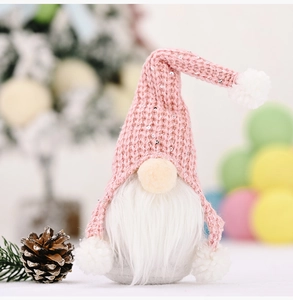 Close-up of pink knitted gnome ornament with silver sequins and white faux fur beard