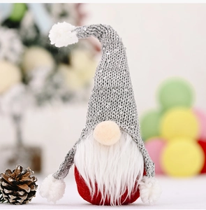Macro detail of Christmas gnome with sequined knit hat and soft white faux fur beard