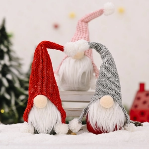 Three sequined Christmas forest gnomes with long white beards on a snowy background