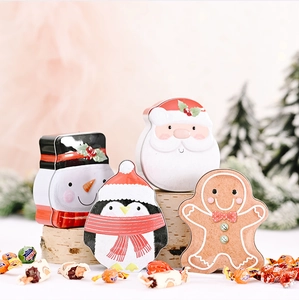 Macro shot of 4 Christmas cartoon tin cans with Santa, Snowman and Gingerbread designs
